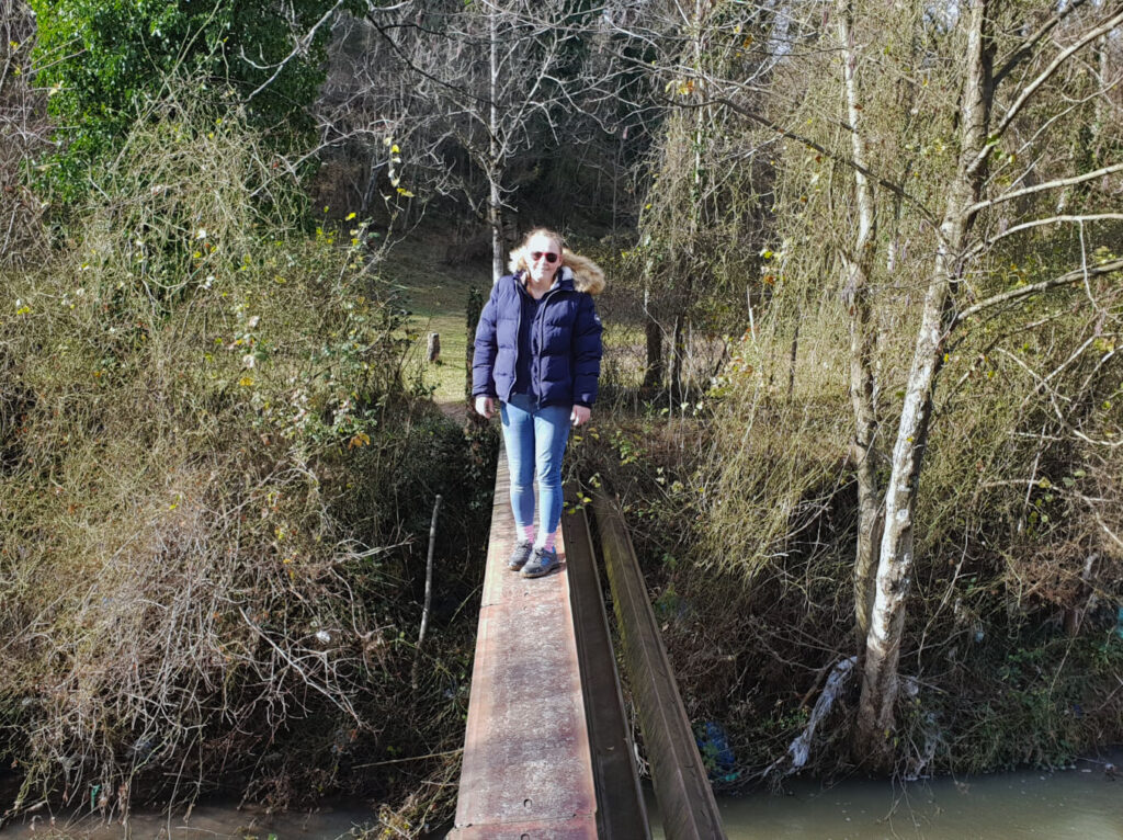 Zoe stood on a 30-centimetre wide metal plank that is acting as a bridge over a stream! Whilst she is smiling for the camera, she is totally scared of falling in. To make things worse, the plank is on an angle!