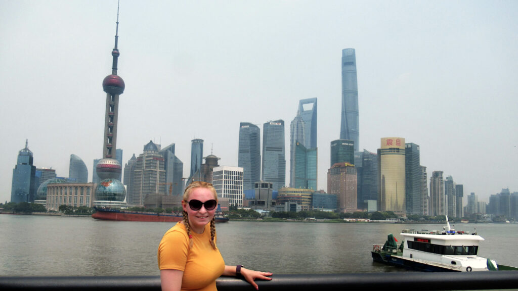 Zoe stood on the Bund with the famous Shanghai skyline behind.