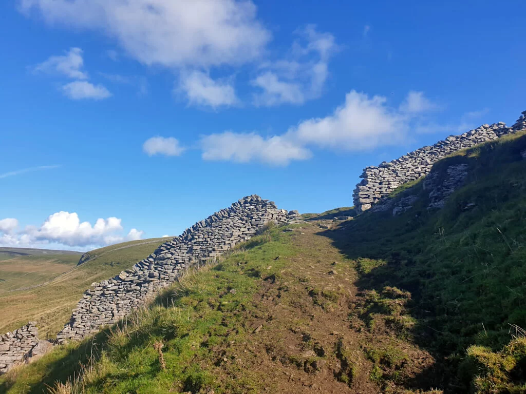 Gaps in the drystone wall guide where the path is going on this Buckden Pike Walk route.