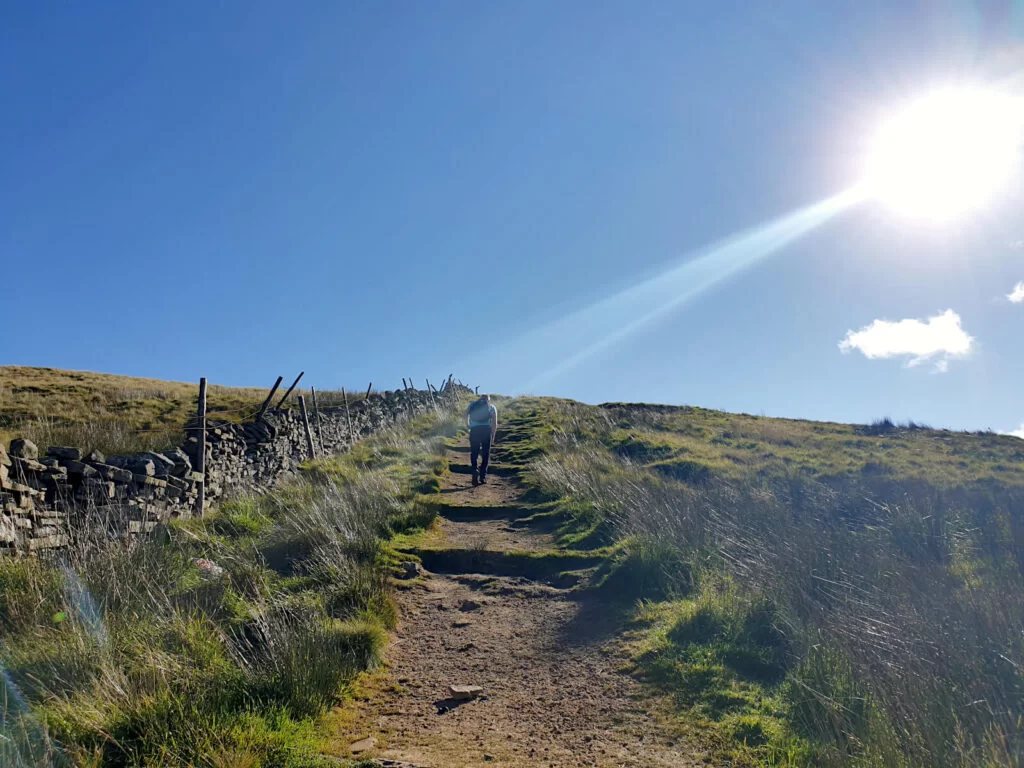 Still climbing towards the sky. The ascent is hard but the views are worth it at the top. The sun beams down on this sunny day in Yorkshire