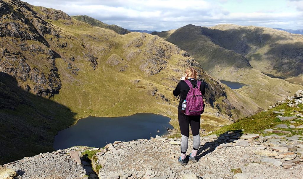 Zoe stood taking a photo of Low Water from the eastern side of the Old Man of Coniston.