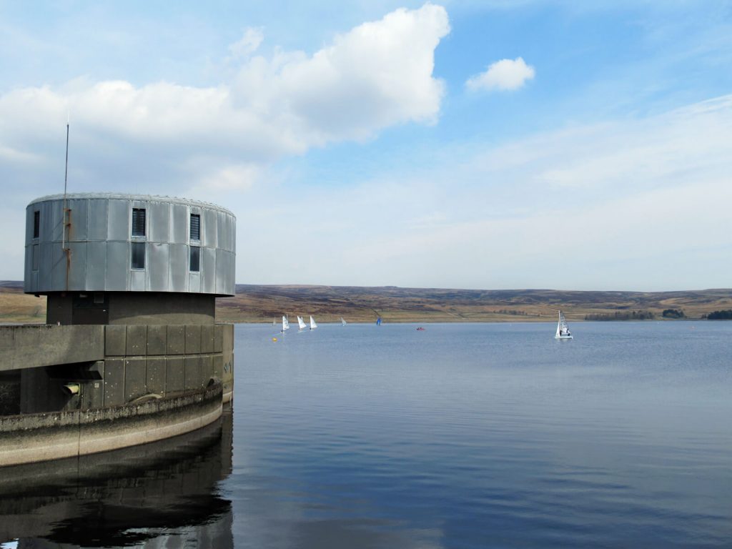 Sailing boats on grimwith reservoir with the watch tower in the foreground