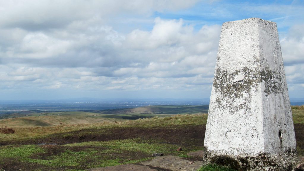 One of the best Peak District Short Walks is to the summit of Shining Tor and back from Pym's Chair car park. In the background you can see the city of Manchester in stark contrast to the rolling Peak District hills and the flat Cheshire plain.
