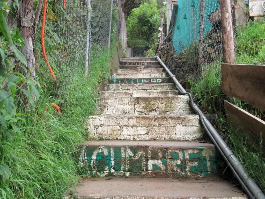 The stairs leading to Cabanas La Cumbre in San Jose del Pacifico. The hostel name is painted on the steps, which lead off from a small road