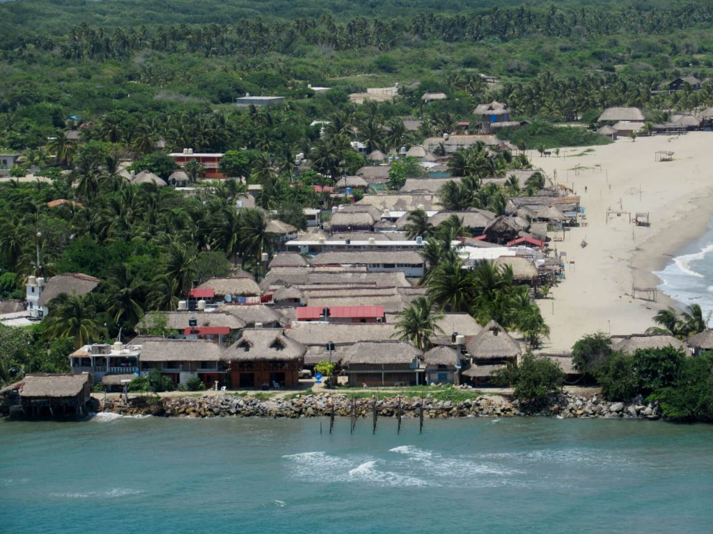 A bird's eye view of the town of Chacahua with it's many cabanas and thatched roofs from the top of the lighthouse