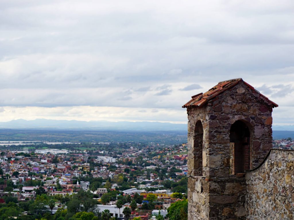 Looking over the city of San Miguel de Allende with a small tower in the foreground