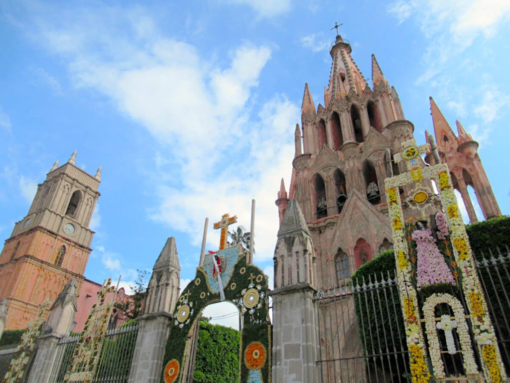 Parroquia de San Miguel Arcangel with various floral pieces in front