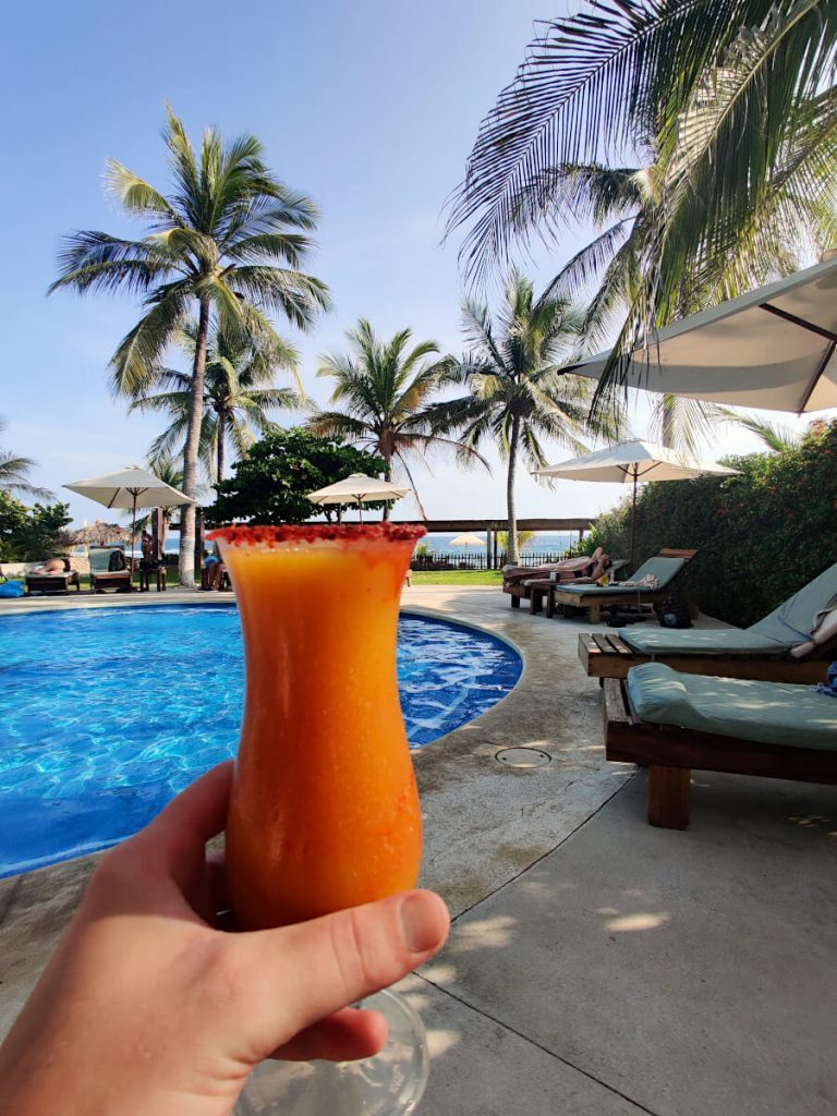 Enjoying a cocktail on a sunny day at Beach Club Villasol, one of two beach clubs on Playa Bacocho