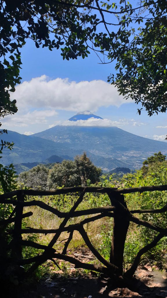 Looking towards Agua Volcano from one of the viewpoints at Hobbitenango. The top of the volcano is hidden behind fluffy white clouds