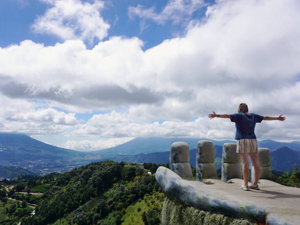 Zoe stood on the Hobbitenango hand. The tops of the volcanos are hidden by cloud but you can see the bases of Agua, Acatenango and Fuego