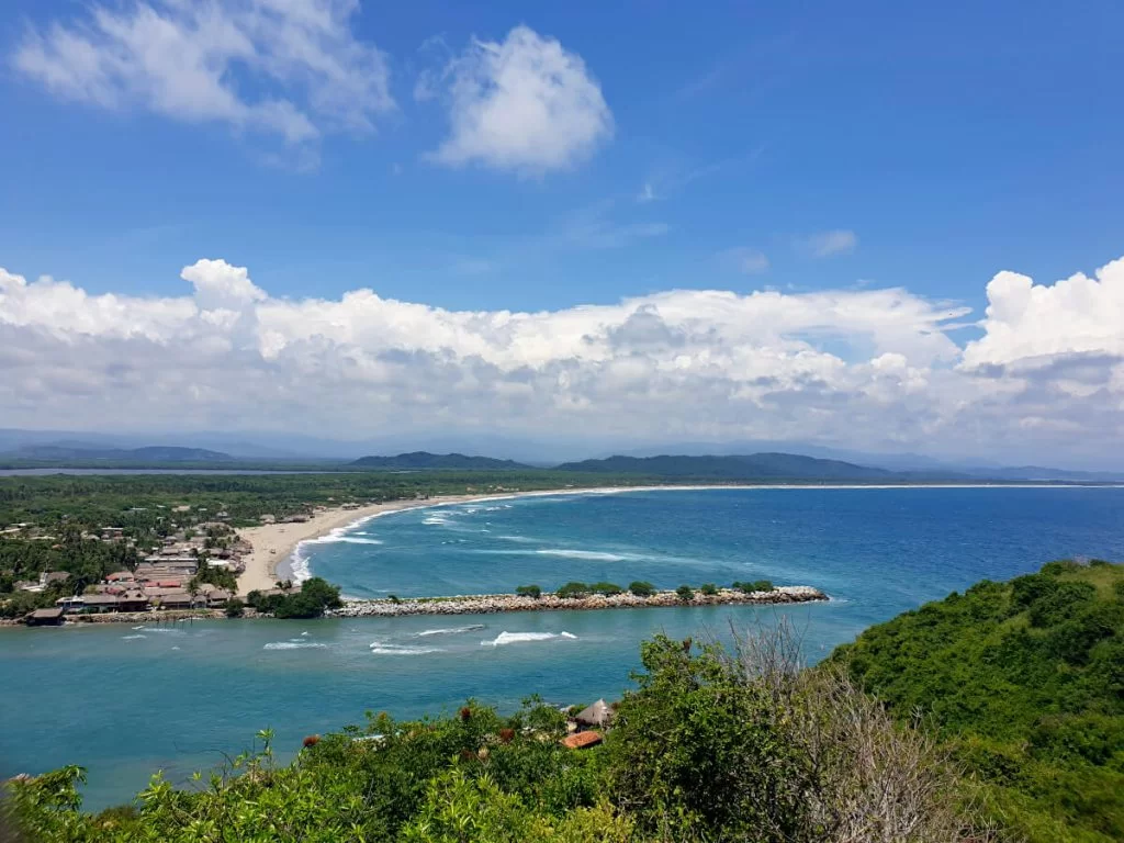 Looking over the vast Playa Chacahua in Lagunas de Chacahua National Park. The golden sands stretch for as far as the eye can see in a jungle-meets-ocean environment